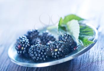 fresh blackberry in metal bowl and on a table