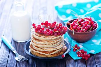 sweet pancakes with red currant on the plate