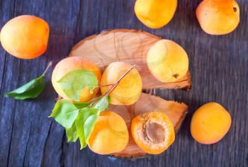 fresh yellow apricots on the wooden table