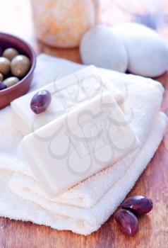 olive soap and towels on a table
