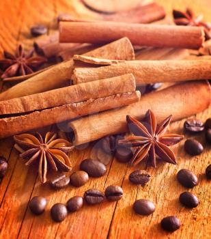 cinnamon, anis and coffee beans on wooden background