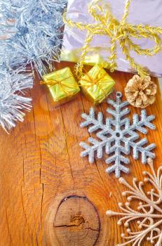 Cristmas decoration on the wooden background, present and snowflakes