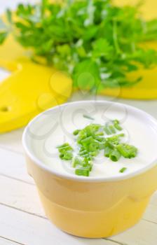 sour cream with green onion on a table