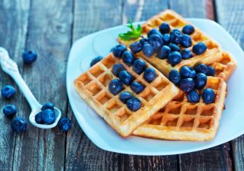waffle with blueberry on the plate and on a table