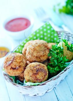 fried meatballs on plate and on a table