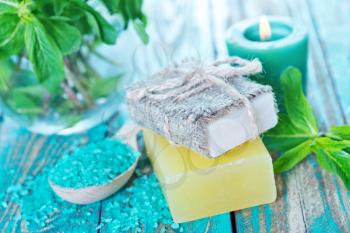 soap and mint leaves on a table