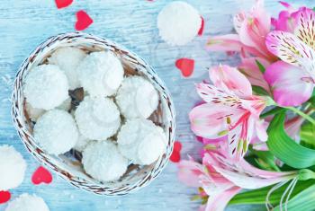 coconut balls in white basket and on a table