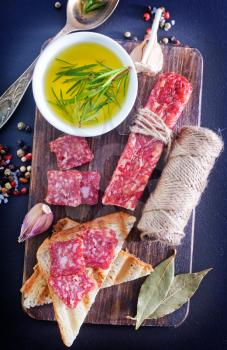 salami and toasts on the wooden board