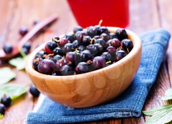 black currant in bowl and on a table