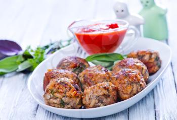 fried meat balls with sauce and spice on the plate