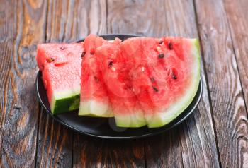 fresh watermelon on plate and on a table