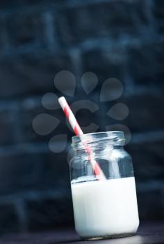 milk in glass bank and on a table