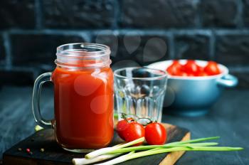 tomato juice in glass bank and on a table