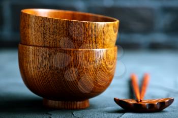 wood bowl with wooden chopsticks on a table