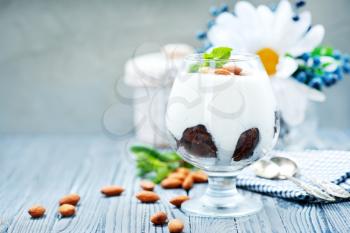 desert with cream and dry almond in glass