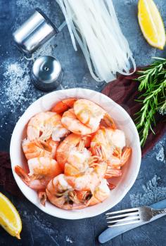boiled shrimps in bowl and on atable