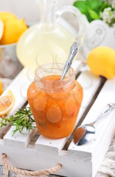lemon jam in glass jar and on a table