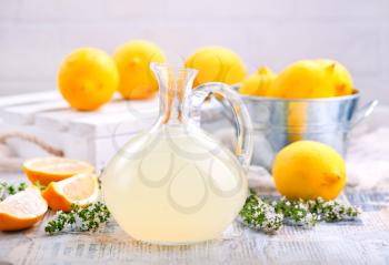 fresh lemon drink in glass jug and on a table