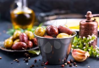 olives with spice in metal bowl and on a table