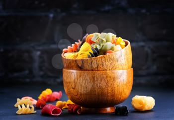 color pasta in bamboo bowls and on a table