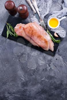 raw chicken fillet with spice on a table