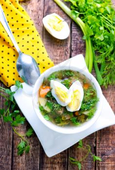 green soup with boiled egg in the bowl