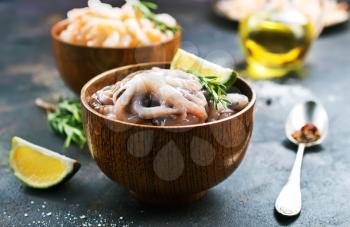 raw octopus in bowls and on a table