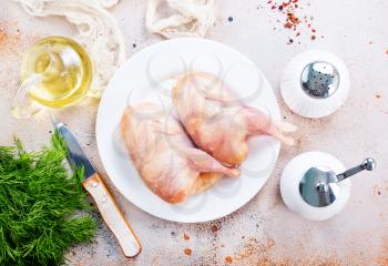 raw quail on white plate, stock photo