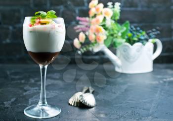Chocolate dessert in glass with fruits.Chocolate mousse or pudding in portion glass with fresh berries