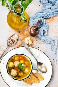 fresh soup with meat balls and vegetables in bowl