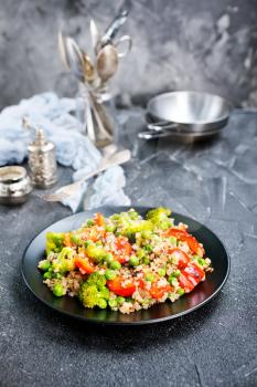 Quinoa salad with pepper, avocado , broccoli and oil . Vegan superfood