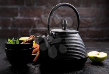  tea with cinnamon and fresh fruit in teapot