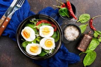 boiled eggs with vegetables in black bowl 