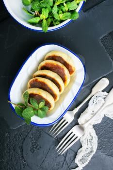 cottage cheese pancakes syrniki on plate, cheese pancakes and mint leaves