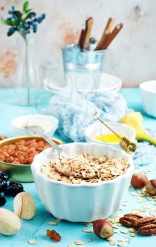 ingredients for helthy breakfast, raw oat flakes with banana and nuts