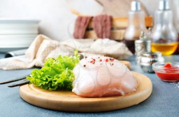 raw chicken fillet with spice and salt
