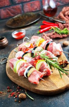 raw kebab with meat and vegetables , meat kebab with eggplant and other vegetables