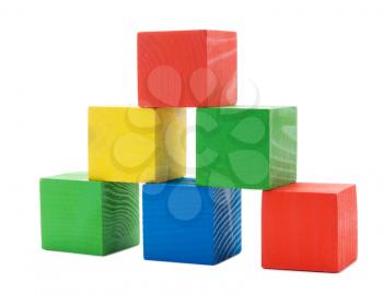 Wooden colored building pyramid of cubes toys isolated on white background