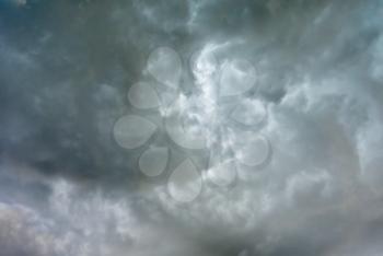 Abstract natural background - dramatic overcast sky with dark stormy ominous clouds before rain.
