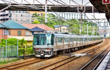 Rapid train is passing Maiko station, Kobe, Japan