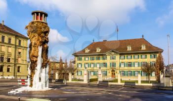 Frozen Meret Oppenheim Fountain and Police office in Bern, Switzerland