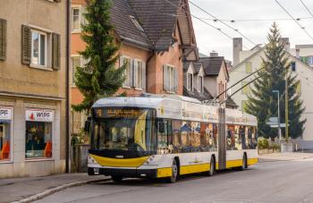 SCHAFFHAUSEN, SWITZERLAND - DECEMBER 01: A modern Hess SwissTrolley 3 trolleybus in Schaffhausen on December 1, 2013. There is a single trolleybus route opened in 1966 in Schaffhausen.