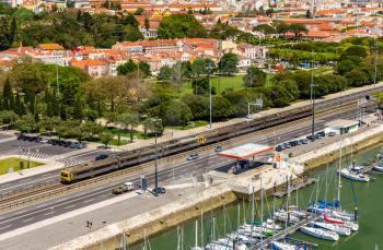 Suburban train passing by a street of Lisbon - Portugal