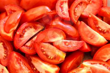 Background of the pieces of ripe chopped tomatoes