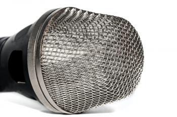 The head of the microphone on ligth background