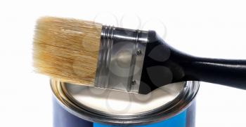 A brush and a can of white paint isolated on white background