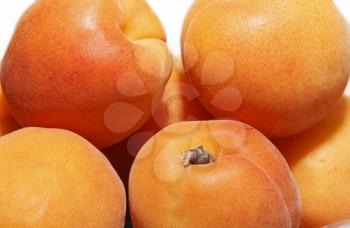 Several ripe large juicy apricots close up