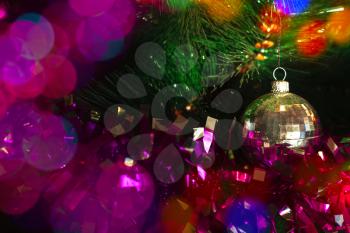 Christmas ball and tinsel on a Christmas tree with bokeh