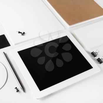 Blank tablet pc and blank stationery on white paper background. Corporate identity template. Mock-up for branding identity for design presentations and portfolios.
