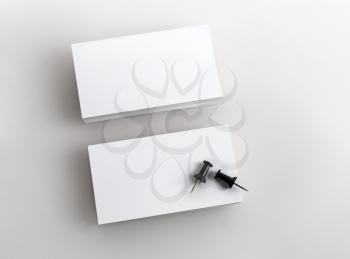 Blank business cards on a gray background. Template for branding identity. Top view.